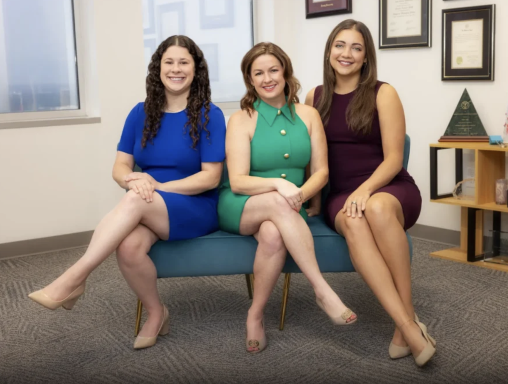 Three women attorneys from Webb Family Law, honored as Women of Influence in D Magazine, sitting together in an office setting.